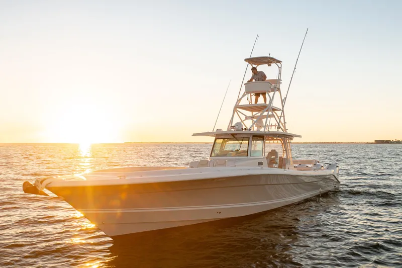 Slide: The Image of 2018 HCB 53 Suenos RXV boat on water at sunset. - 3