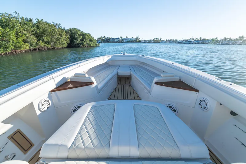 Slide: The Image of Luxurious 2018 HCB 53 Suenos RXV boat interior with white seating on calm water. - 39