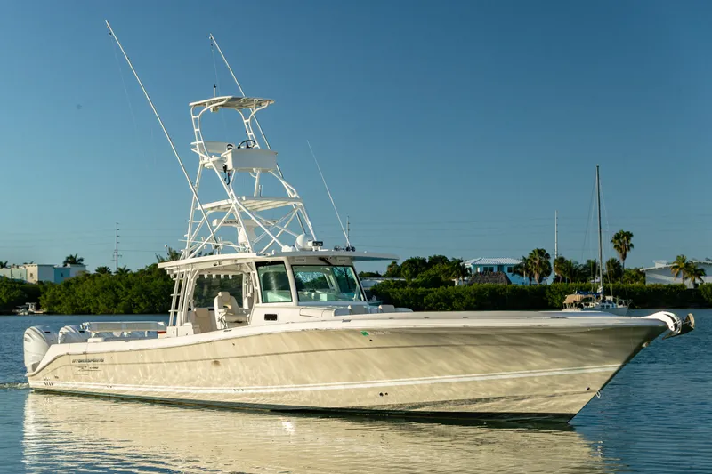 Slide: The Image of 2018 HCB 53 Suenos RXV boat on calm water, clear sky background. - 4