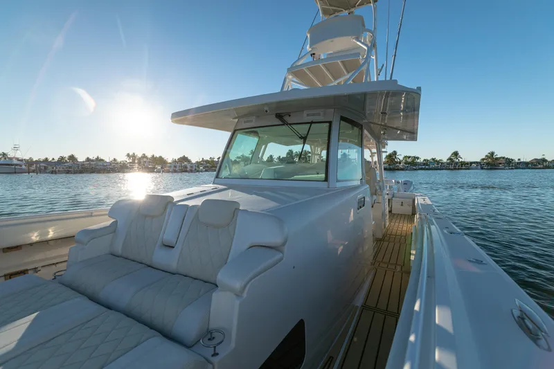 Slide: The Image of 2018 HCB 53 Suenos RXV yacht on water at sunset, showcasing luxury seating. - 43