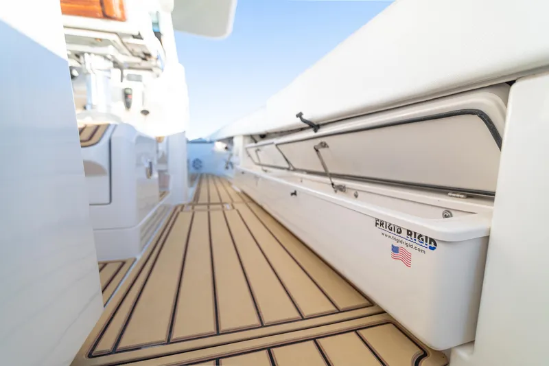 Slide: The Image of 2018 HCB 53 Suenos RXV boat interior with teak flooring and storage compartments. - 47