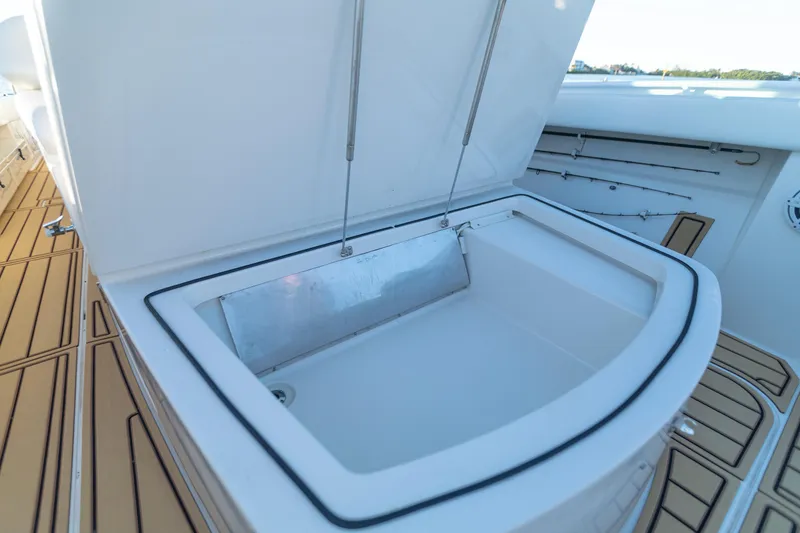 Slide: The Image of Open storage compartment on 2018 HCB 53 Suenos RXV boat deck. - 48