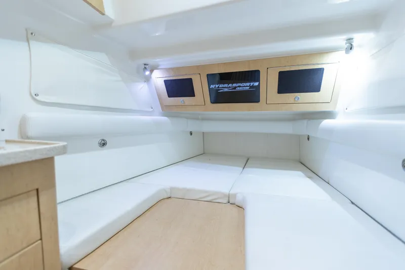 Slide: The Image of Interior cabin of 2018 HCB 53 Suenos RXV, featuring white seating and wooden accents. - 51
