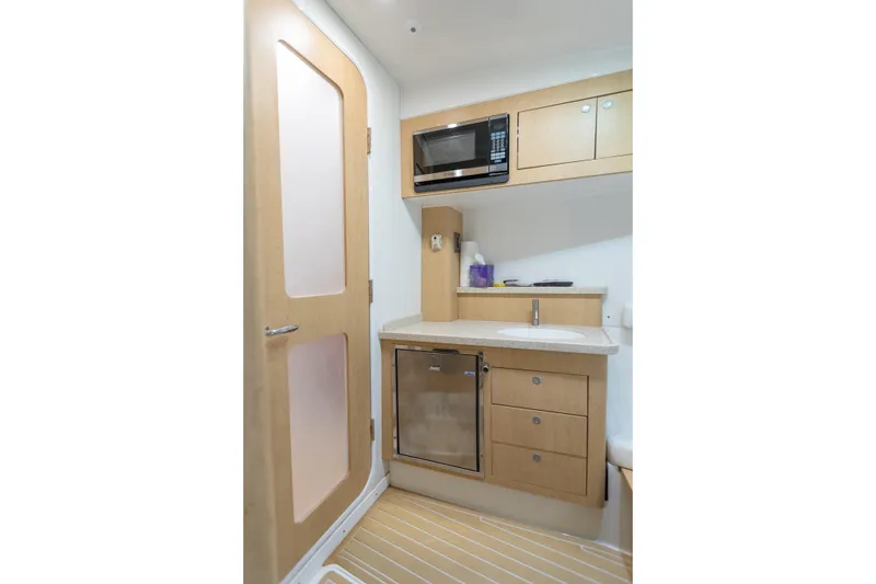 Slide: The Image of Compact kitchenette in 2018 HCB 53 Suenos RXV with microwave, sink, and storage cabinets. - 53