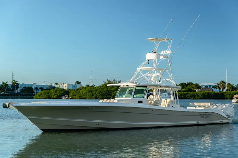 Slide: The Image of 2018 HCB 53 Suenos RXV boat on calm water, clear sky background. - 9