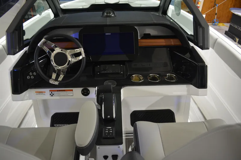 Slide: The Image of 2026 Monterey Elite 25 OB boat dashboard with modern steering wheel and digital display. - 19