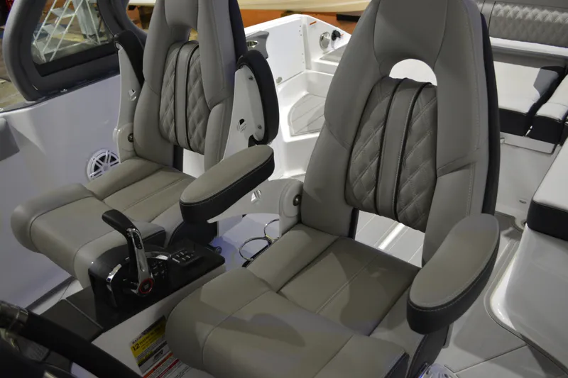 Slide: The Image of Luxury seating in 2026 Monterey Elite 25 OB boat cockpit, featuring plush, ergonomic design. - 23