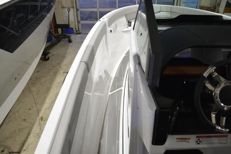 Slide: The Image of 2026 Monterey Elite 25 OB boat interior with sleek design and modern steering wheel. - 26