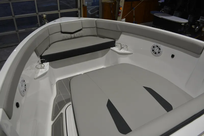 Slide: The Image of 2026 Monterey Elite 25 OB boat interior with cushioned seating and cup holders. - 27