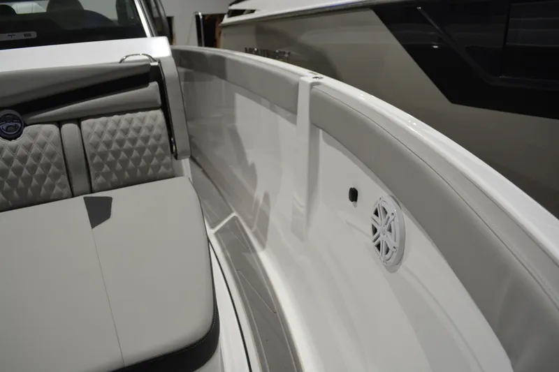 Slide: The Image of Interior view of 2026 Monterey Elite 25 OB boat with cushioned seating and speaker. - 31