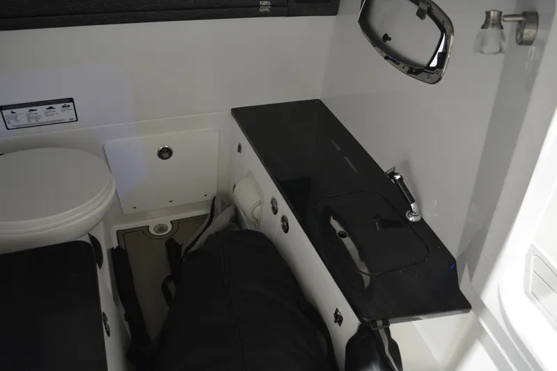 Slide: The Image of 2026 Monterey Elite 25 OB boat interior with sink and toilet. - 32