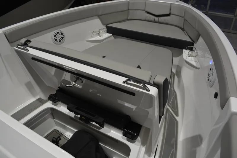 Slide: The Image of 2026 Monterey Elite 25 OB boat interior with cushioned seating and storage compartments. - 34