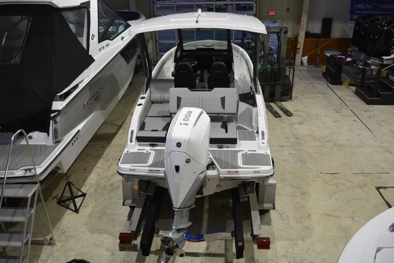 Slide: The Image of 2026 Monterey Elite 25 OB boat with powerful outboard motor in showroom. - 6