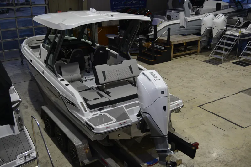 Slide: The Image of 2026 Monterey Elite 25 OB boat in showroom, featuring sleek design and powerful outboard engine. - 7