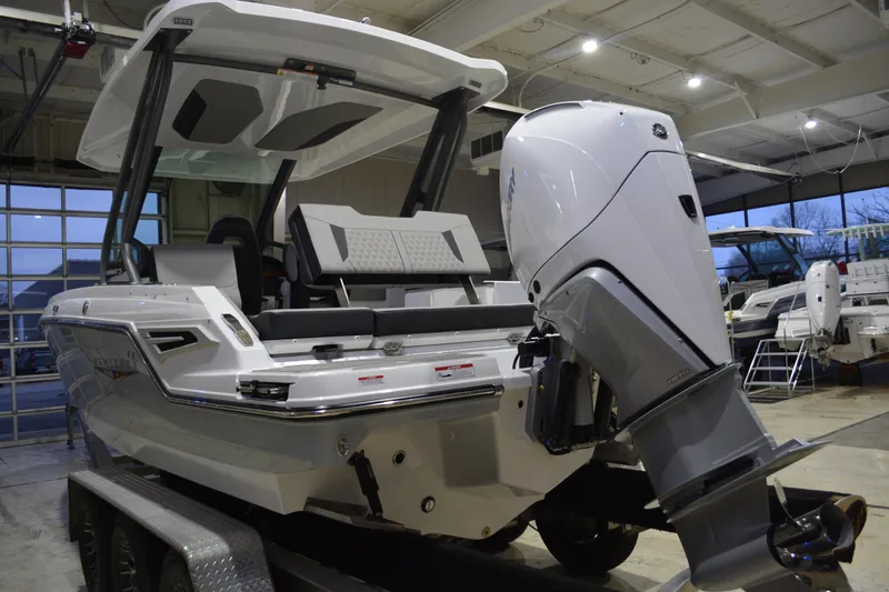 Slide: The Image of 2026 Monterey Elite 25 OB boat with powerful outboard motor in showroom. - 9