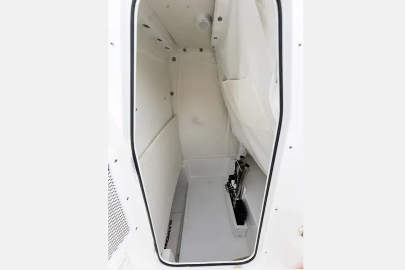 Slide: The Image of Manufacturer Provided Image: Interior cabin of 2026 Sea Hunt Ultra 239 SE boat, featuring white upholstery. - 10