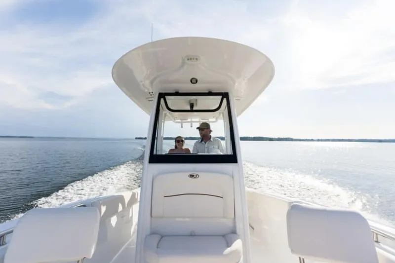 Slide: The Image of Manufacturer Provided Image: 2026 Sea Hunt Ultra 239 SE boat cruising on open water, two people onboard. - 6