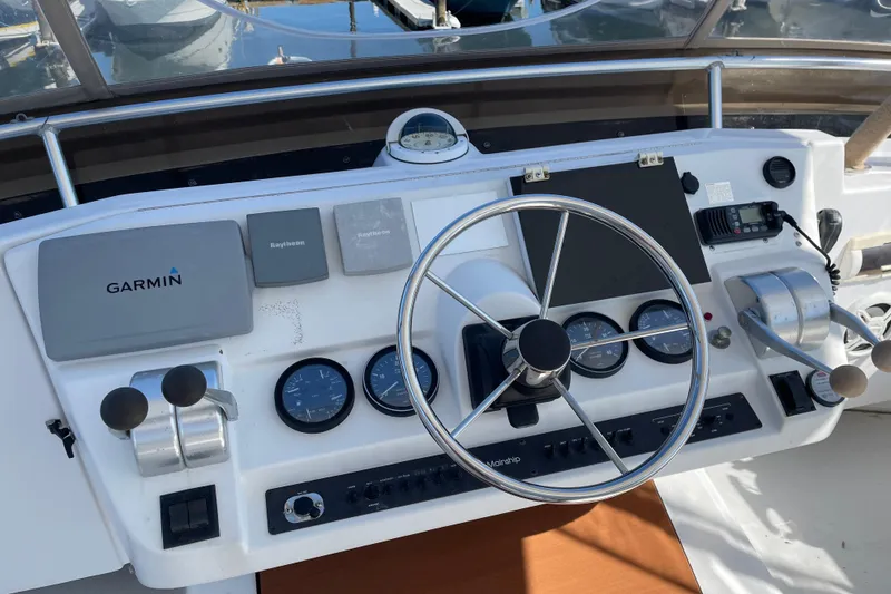 Slide: The Image of 1999 Mainship 430 Trawler helm with Garmin navigation and control instruments. - 14