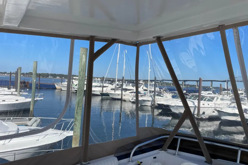 Slide: The Image of 1999 Mainship 430 Trawler docked at marina with other boats in view. - 16