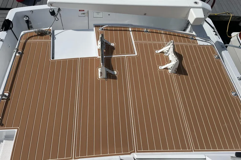 Slide: The Image of 1999 Mainship 430 Trawler deck with brown and white striped flooring. - 17