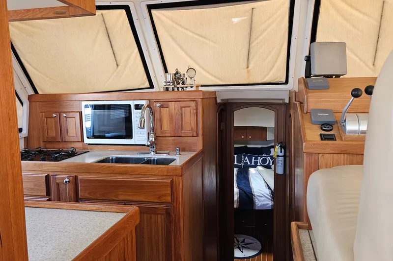 Slide: The Image of Interior of 1999 Mainship 430 Trawler with kitchen and cozy cabin view. - 5