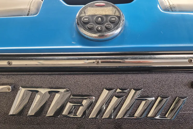 Slide: The Image of 2014 Malibu Wakesetter 24 MXZ dashboard with control panel and logo. - 10