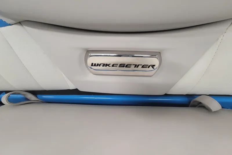 Slide: The Image of 2014 Malibu Wakesetter 24 MXZ interior detail with logo on white upholstery. - 13