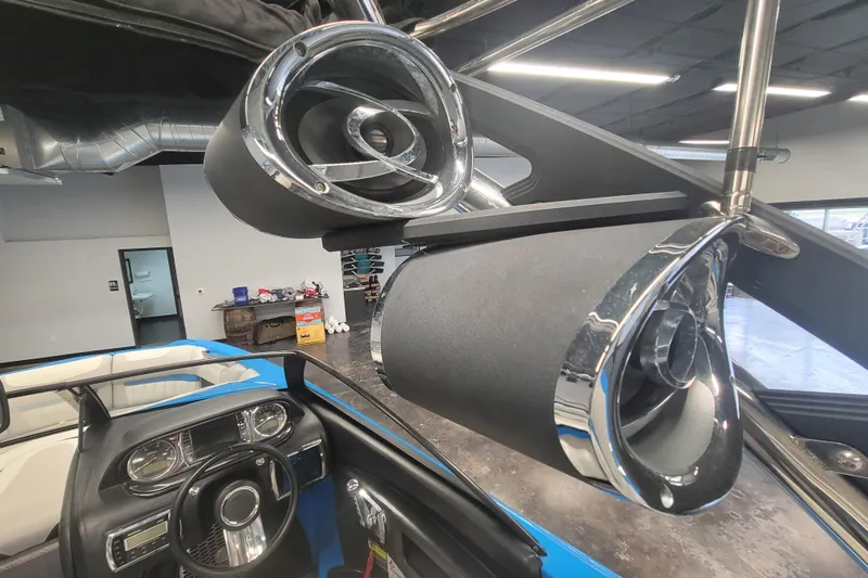 Slide: The Image of 2014 Malibu Wakesetter 24 MXZ interior with chrome speakers and dashboard view. - 15