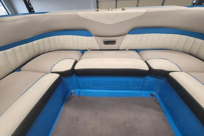 Slide: The Image of 2014 Malibu Wakesetter 24 MXZ interior with blue and white seating. - 20