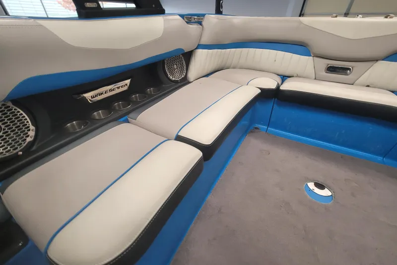 Slide: The Image of Interior of 2014 Malibu Wakesetter 24 MXZ boat with blue and gray seating. - 21