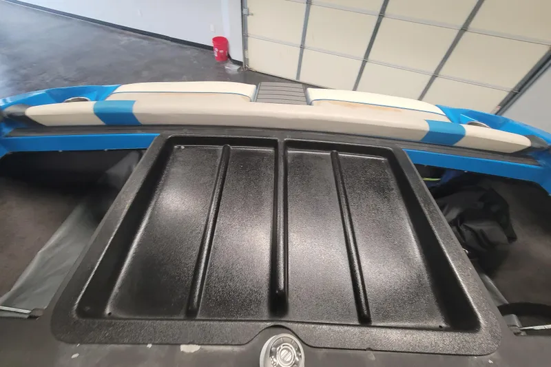 Slide: The Image of 2014 Malibu Wakesetter 24 MXZ boat interior with blue and white seating. - 22