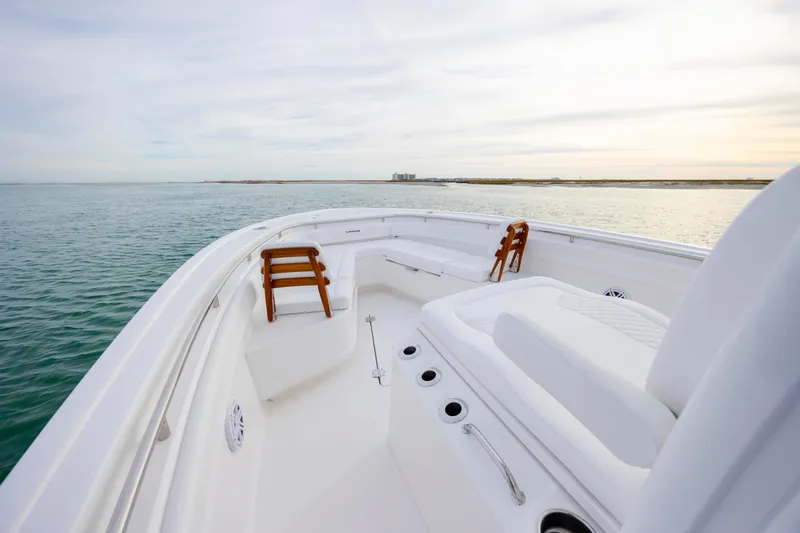 Slide: The Image of 2026 Caymas 291 boat deck with seating, overlooking calm ocean waters. - 11
