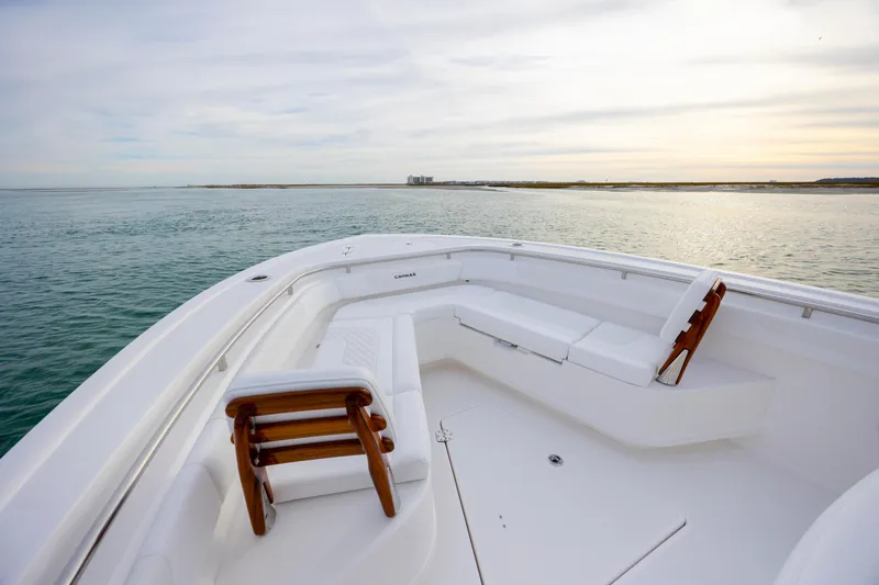 Slide: The Image of 2026 Caymas 291 boat with spacious seating, cruising on calm waters at sunset. - 12