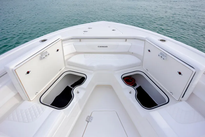 Slide: The Image of 2026 Caymas 291 boat interior with open storage compartments on calm water. - 14