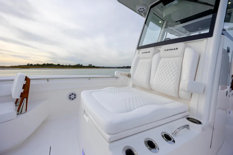 Slide: The Image of 2026 Caymas 291 boat interior with luxurious white seating and scenic water view. - 17