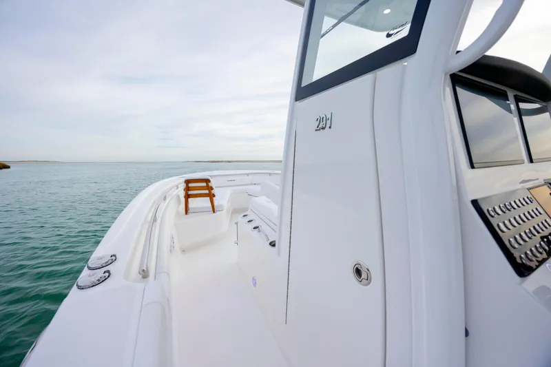 Slide: The Image of 2026 Caymas 291 boat on calm water, showcasing sleek design and modern features. - 19