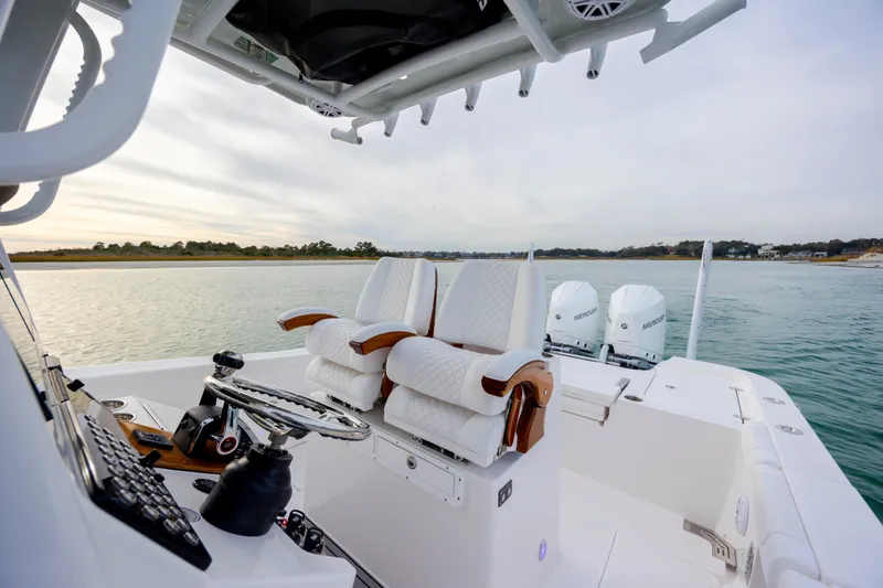 Slide: The Image of 2026 Caymas 291 boat interior with luxurious seating and dual Mercury engines. - 21