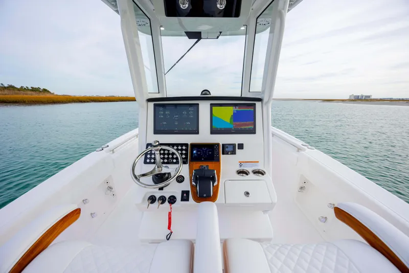 Slide: The Image of 2026 Caymas 291 boat cockpit with modern navigation system on calm water. - 22