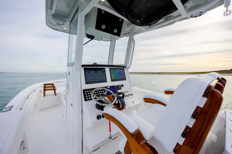 Slide: The Image of 2026 Caymas 291 boat interior with modern helm and luxurious seating on open water. - 24