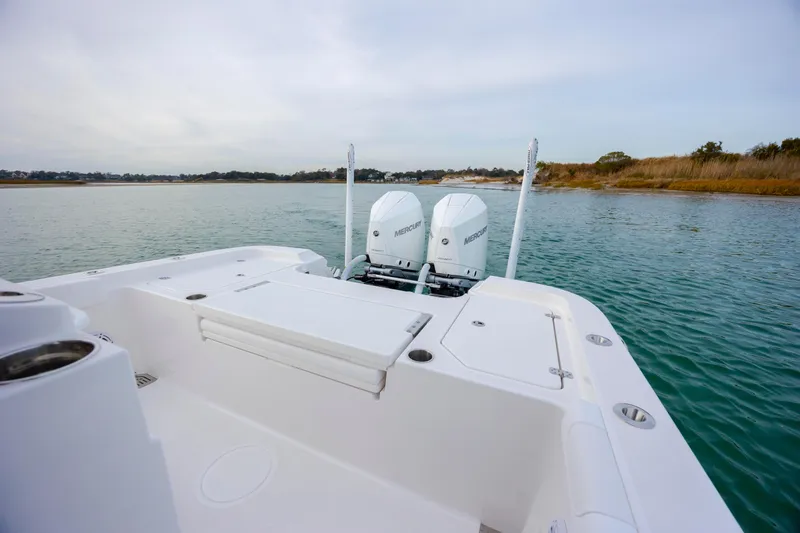 Slide: The Image of 2026 Caymas 291 boat with dual Mercury engines on a serene waterway. - 29