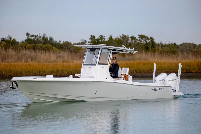 Slide: The Image of 2026 Caymas 291 boat cruising on calm water with scenic background. - 3