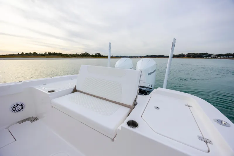 Slide: The Image of 2026 Caymas 291 boat with dual Mercury engines on calm water. - 30