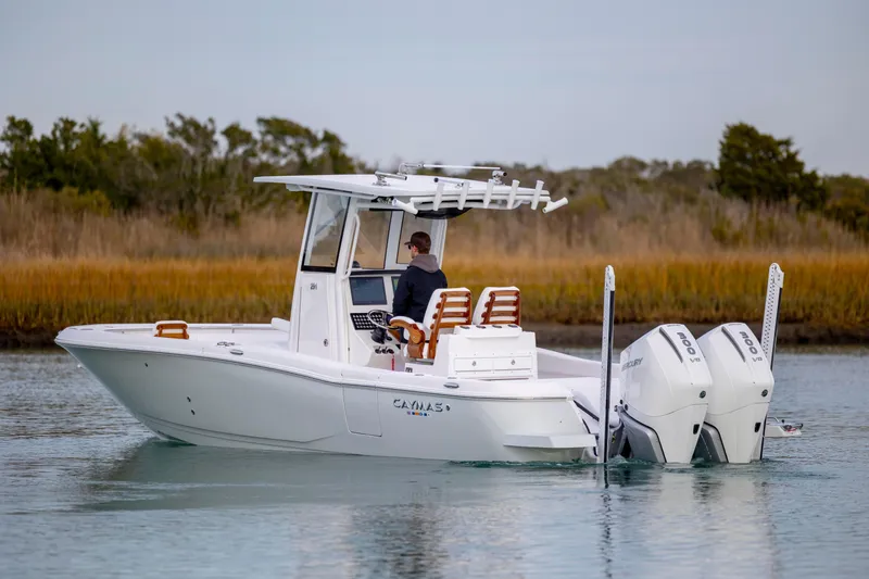 Slide: The Image of 2026 Caymas 291 boat with dual engines cruising on calm water. - 5