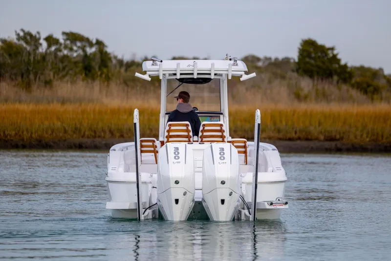 Slide: The Image of 2026 Caymas 291 boat with dual 300 V8 engines on calm water. - 6