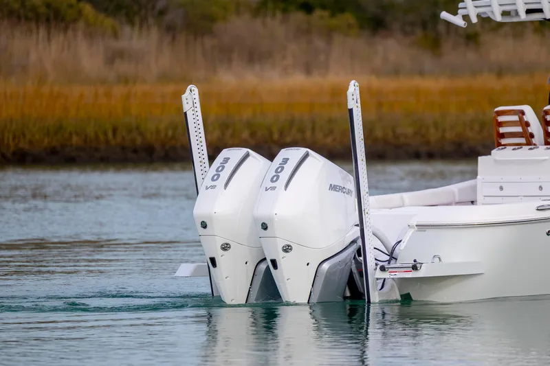 Slide: The Image of 2026 Caymas 291 boat with dual Mercury 300 V8 engines on calm water. - 8