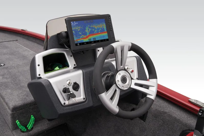 Slide: The Image of 2025 Tracker Savage 215 boat interior with gray and red seating, steering console, and carpeted floor. - 30