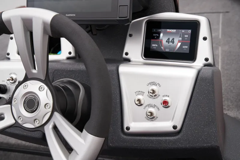 Slide: The Image of Interior of 2025 Tracker Savage 215 boat with gray seating and carpeted flooring. - 33