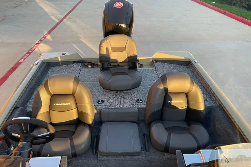 Slide: The Image of 2026 Tracker Pro Team 195 boat interior with three cushioned seats and steering wheel. - 5