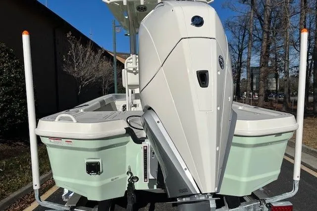 Slide: The Image of 2026 Mako 24 APEX boat with powerful outboard motor, parked outdoors. - 3