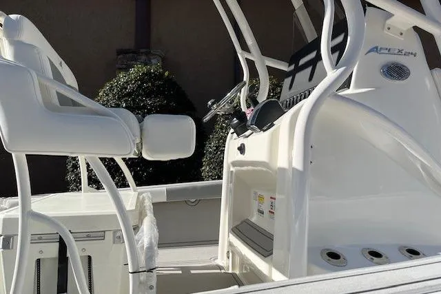 Slide: The Image of 2026 Mako 24 APEX boat interior with white seating and control console. - 5
